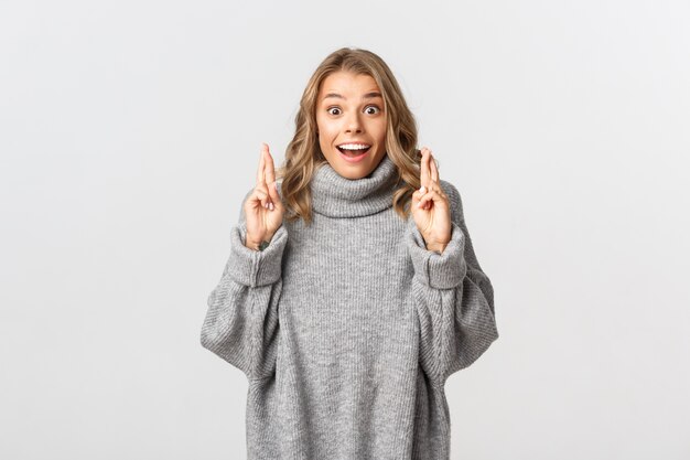 Beautiful woman in a grey sweater posing