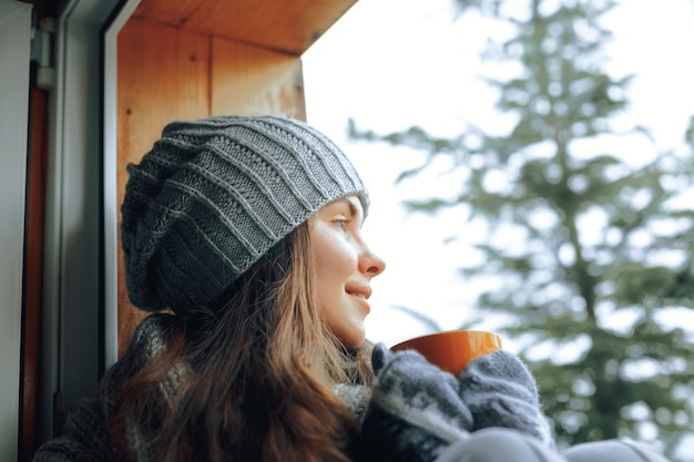 Beautiful woman holding and drinking a cup of coffee