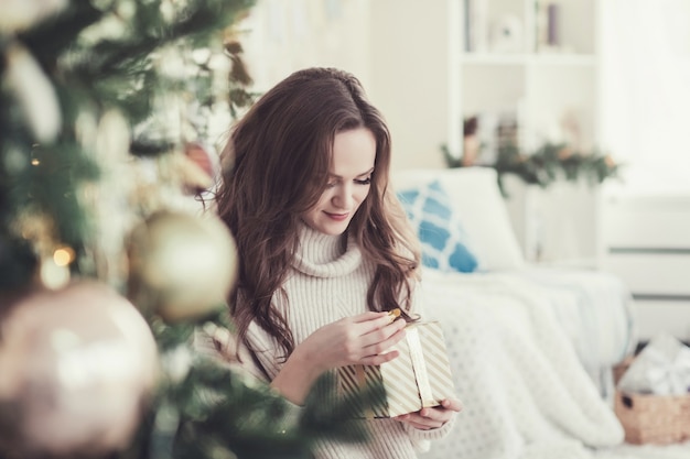 Beautiful woman holding a gift box