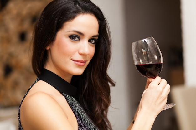 Beautiful woman holding a glass of red wine