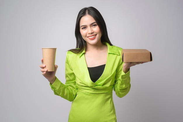 Beautiful woman holding paper cup and paper box over white background Save earth concept