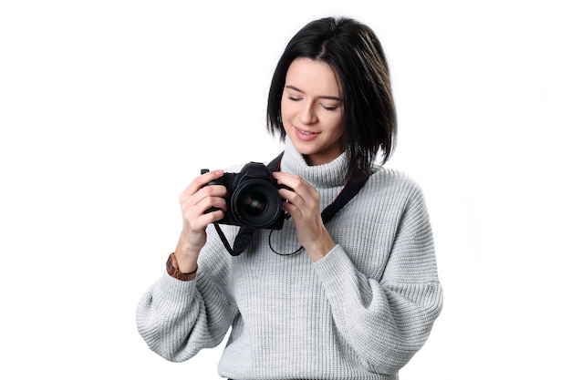 Beautiful woman holding a photo camera Isolated over white background