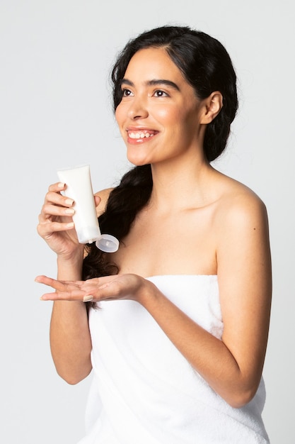 Beautiful woman holding a skin care product