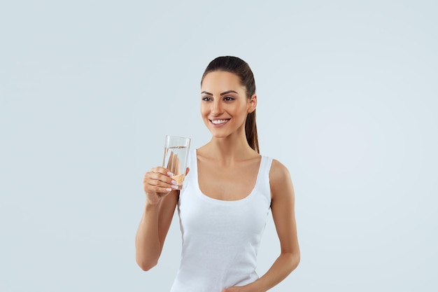 Beautiful woman holding water glass Drink water Girl with glass of water Diet concept