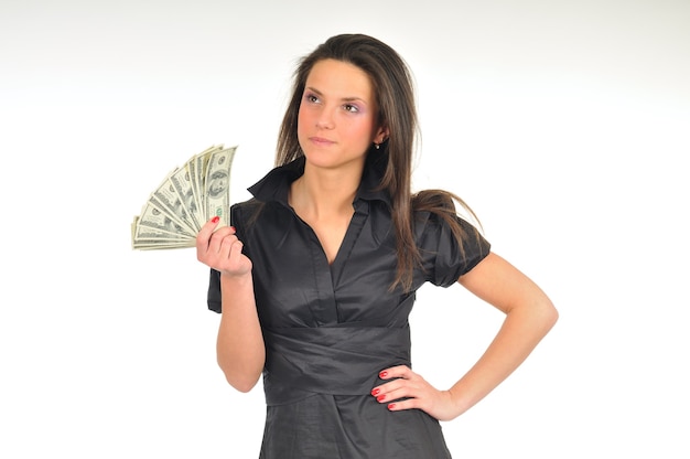 Beautiful woman holds dollar bills in her hands, full length photo, isolated on white wall