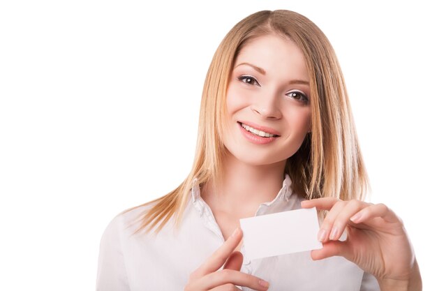 Beautiful woman holds out business or credit card Isolated on white background