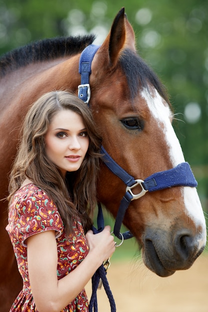 Beautiful woman and horse outdoors.