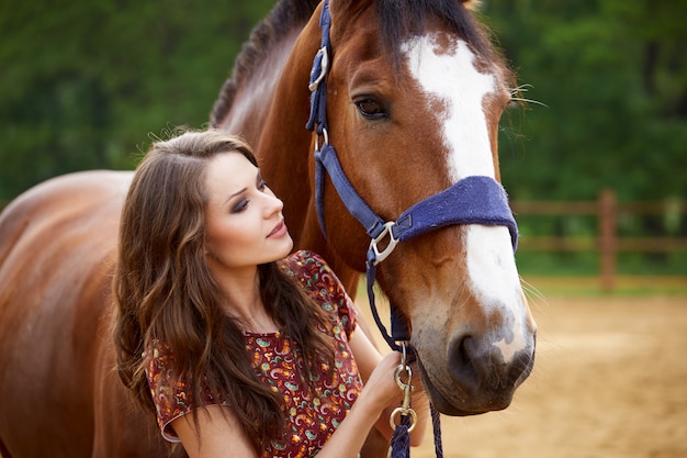 Beautiful woman and horse outdoors.