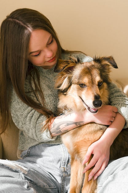 Beautiful woman hugging her dog home lifestyle portrait