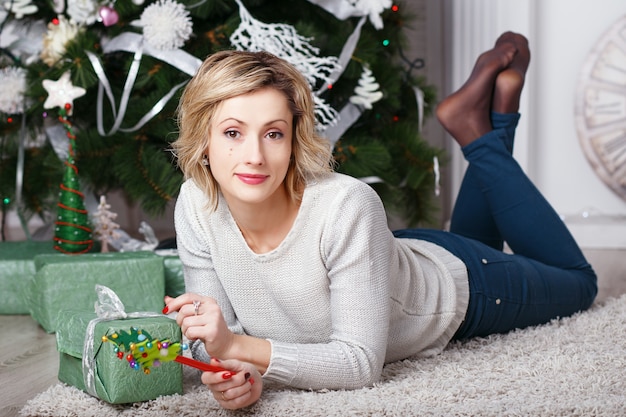 Beautiful woman in the interior with Christmas decorations