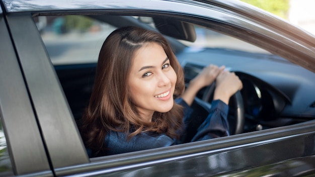 Beautiful woman is driving her car 