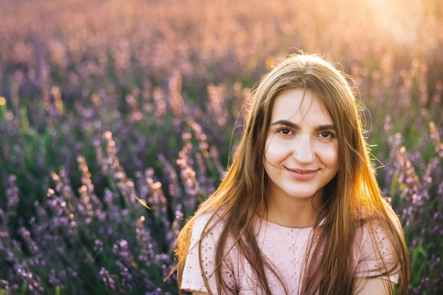 Beautiful woman is posing at field of purple lavender flowers beautiful woman in the lavender field