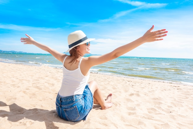 Beautiful woman is sitting on beach 