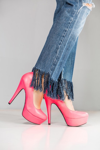 beautiful woman legs wearing high heels and jeans