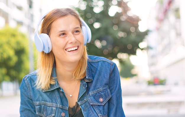 Beautiful woman listening music with headphone