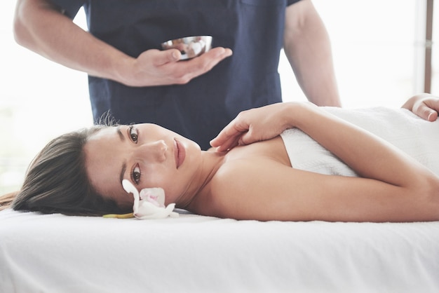 Beautiful woman lying on massage table in Spa.