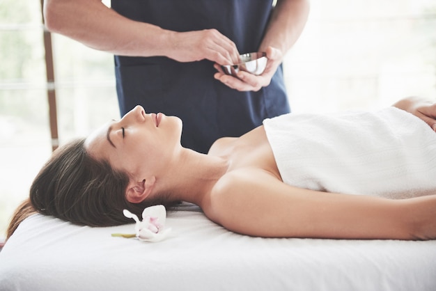 Beautiful woman lying on massage table in Spa.