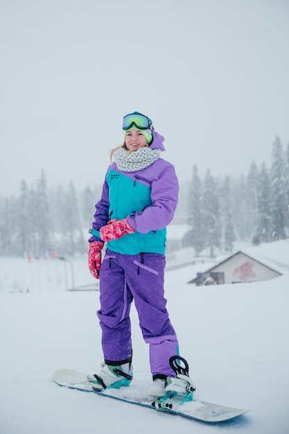 beautiful woman at mountain on snowboard