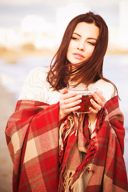 Beautiful woman in plaid on a field