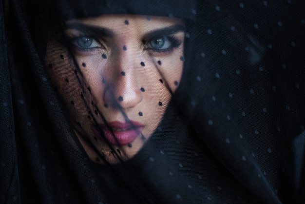 Beautiful woman portrait under black veil