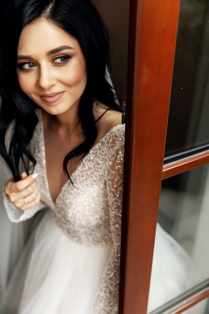 The beautiful woman posing in a wedding dress