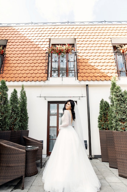 The beautiful woman posing in a wedding dress