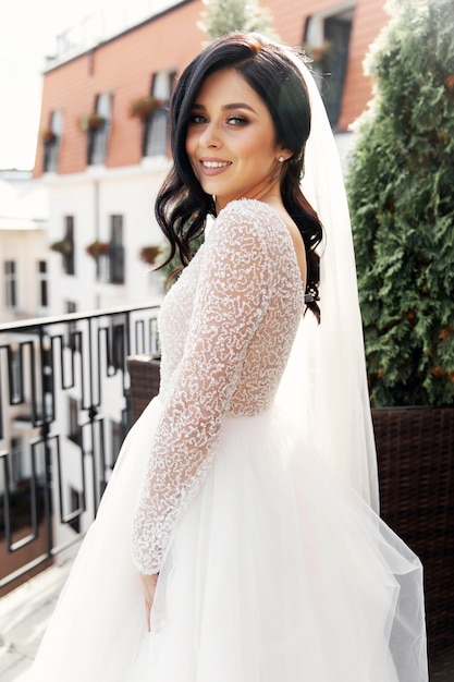 The beautiful woman posing in a wedding dress