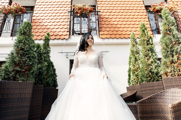 The beautiful woman posing in a wedding dress