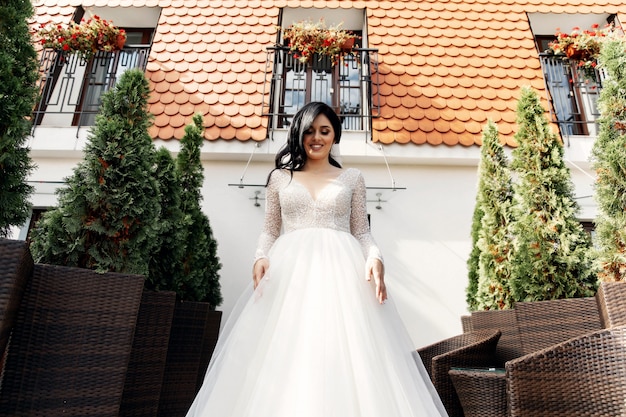 The beautiful woman posing in a wedding dress