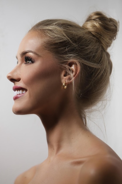 Beautiful woman in profile with her hair in a ponytail smiling