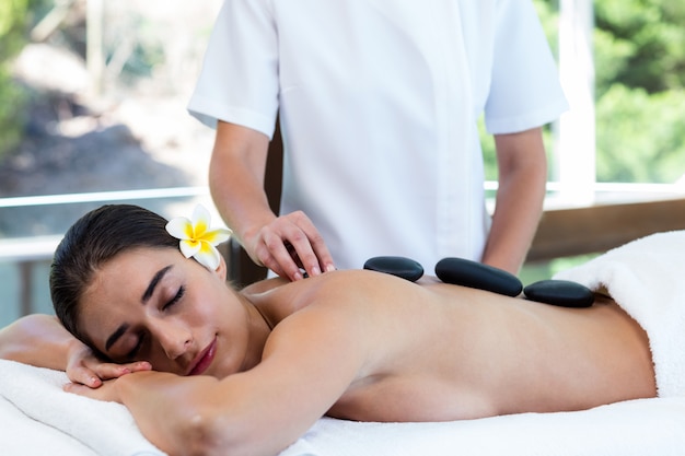 Beautiful woman receiving stone massage