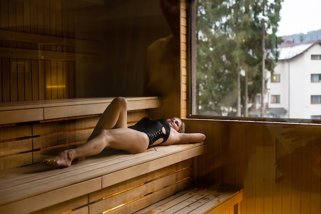 Beautiful woman relaxing a sauna