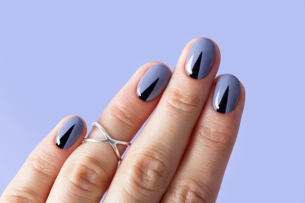 Beautiful woman's nails with geometric minimal manicure