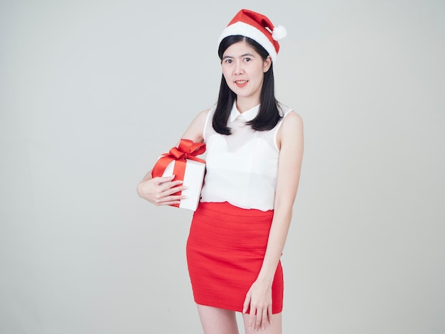 Beautiful woman in santa hat holding gift box