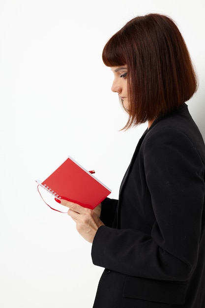 Beautiful woman short haired red notepad and pencil isolated background