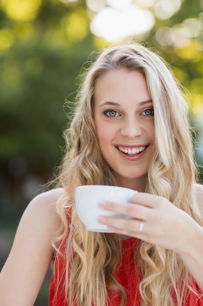 Beautiful woman smiling while having coffee