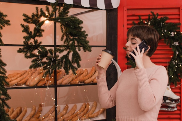 Beautiful woman speaks by phone. New year concept