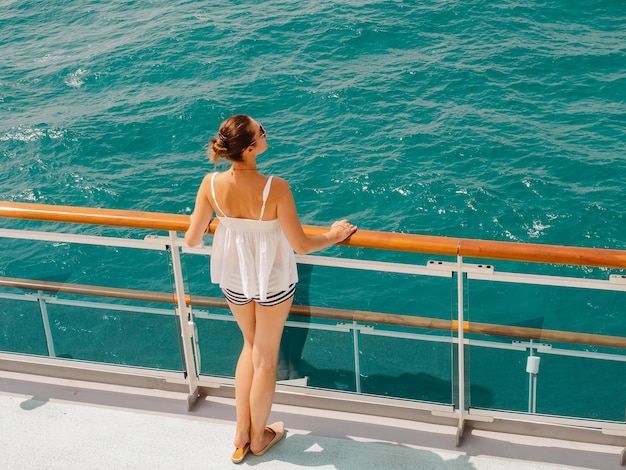 Beautiful woman standing on the empty deck