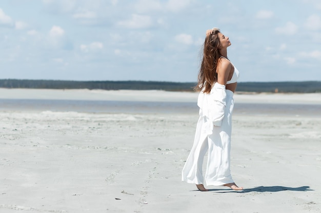 Beautiful woman standing on seashore