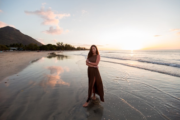 Beautiful woman on sunset background