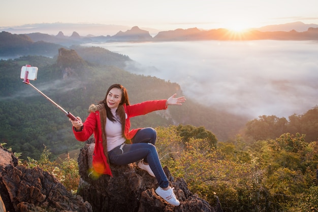 A beautiful woman taking a selfie on Phu Pha Mok Ban Jabo in Mae Hong Son Province, Thailand.