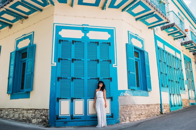 Beautiful woman in town. Woman walking through the streets. Stylish cafe. Streets of the old city. Woman by the wall