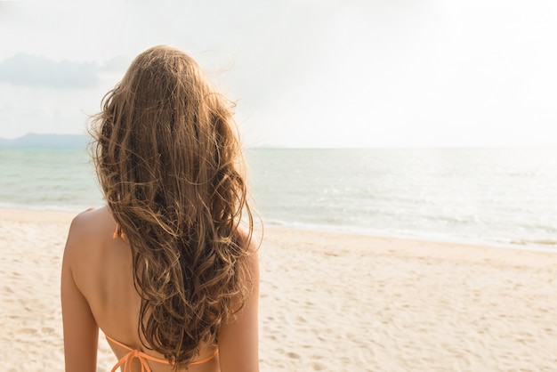 Beautiful woman at tropical beach in summer