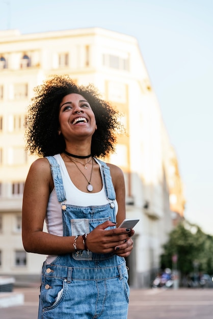 Beautiful woman using mobile in the Street. Youth concept.