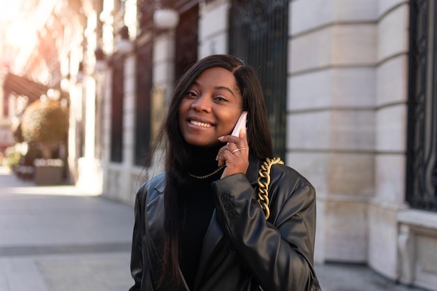 Beautiful woman using the phone. Young businesswoman talking to the phone