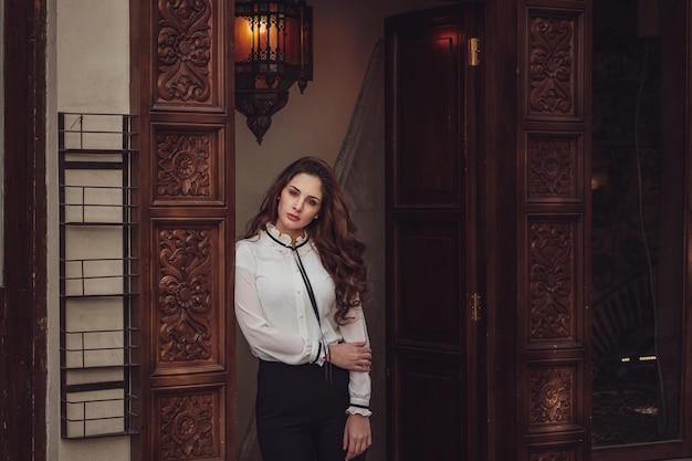 Beautiful woman walks at Istiklal streeta popular location in Beyoglu districtIstanbulTurkey lifestyle fashion portrait of young stylish woman