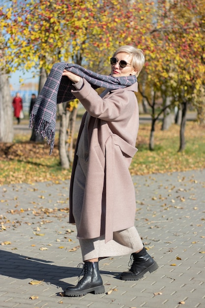 Beautiful woman walks in the park in autumn. High quality photo