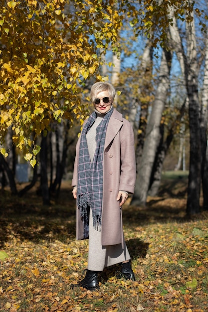 Beautiful woman walks in the park in autumn. High quality photo