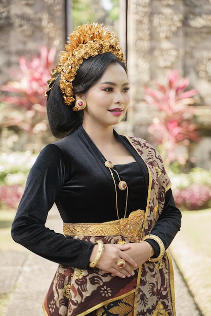 Beautiful woman wearing traditional balinese clothes standing