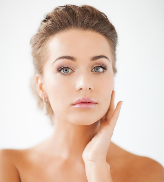 beautiful woman in white dress and diamond earrings